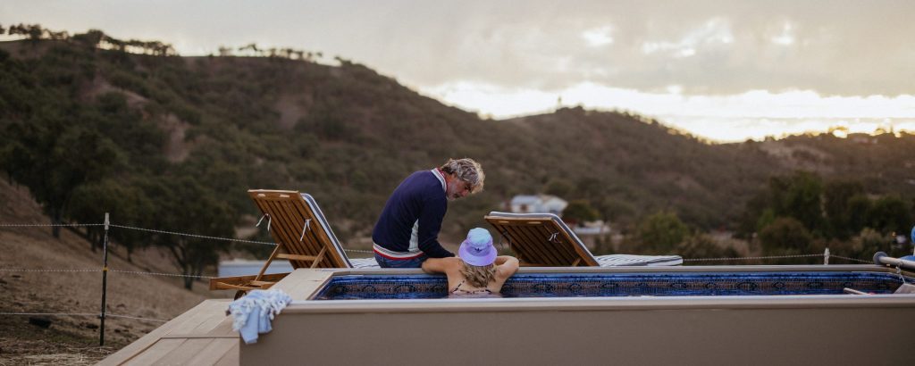 Two people by a poolside.