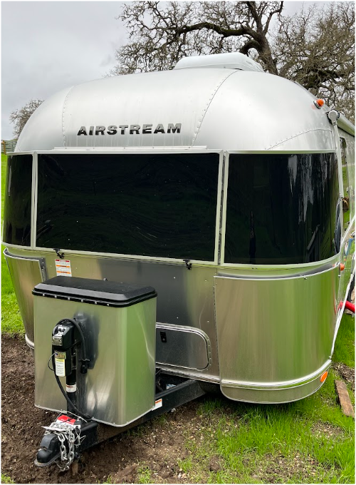 Vintage silver Airstream trailer parked on a ranch property in Paso Robles.