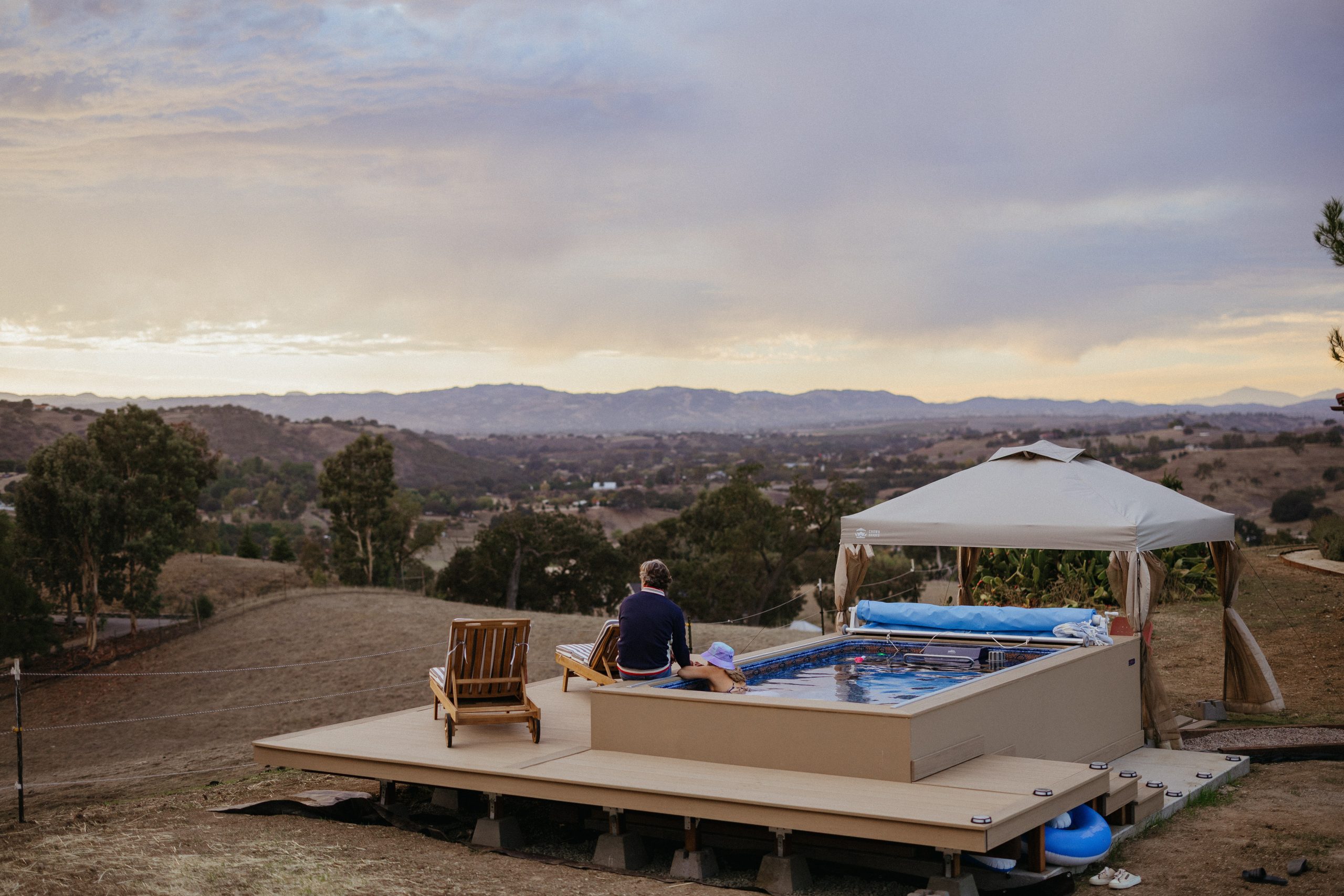 Person relaxing by a poolside