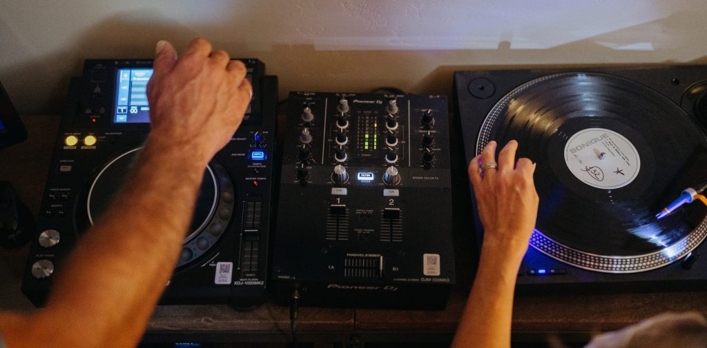 DJ equipment with hands mixing music