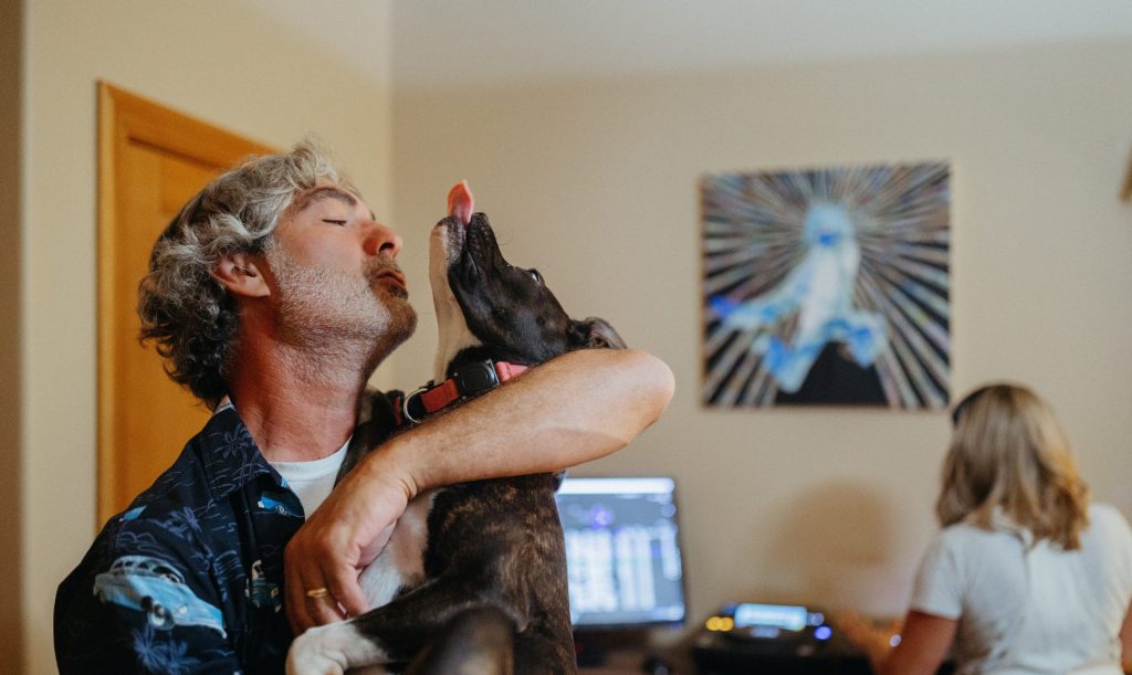 Man with dog in front of DJ set up