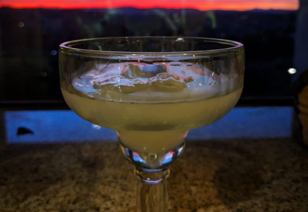 Margarita glass against sunset backdrop