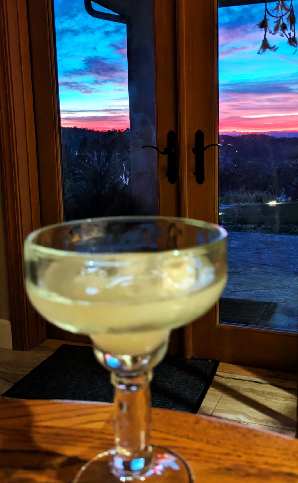 Cocktail with sunset view behind