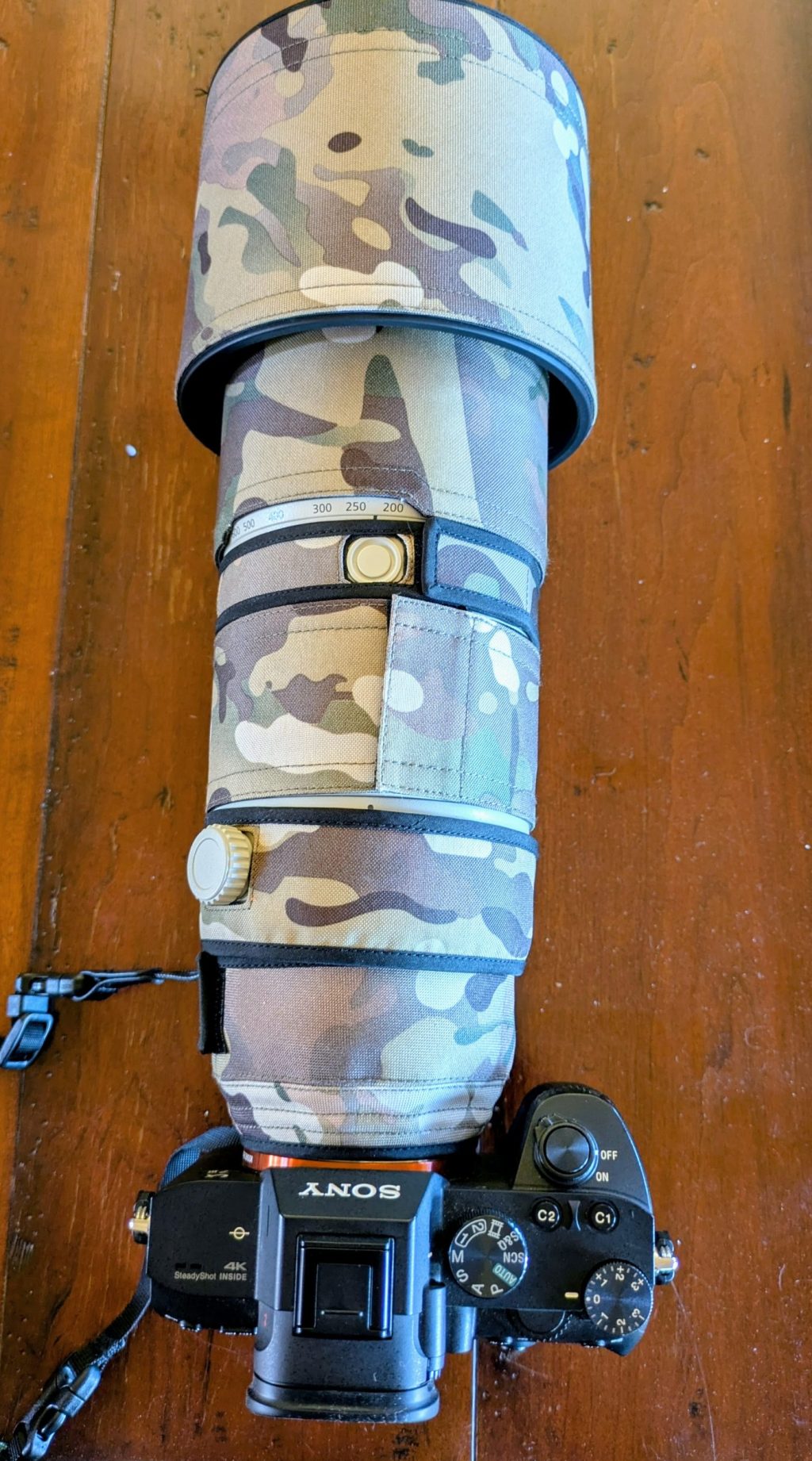 Camouflaged camera with large lens