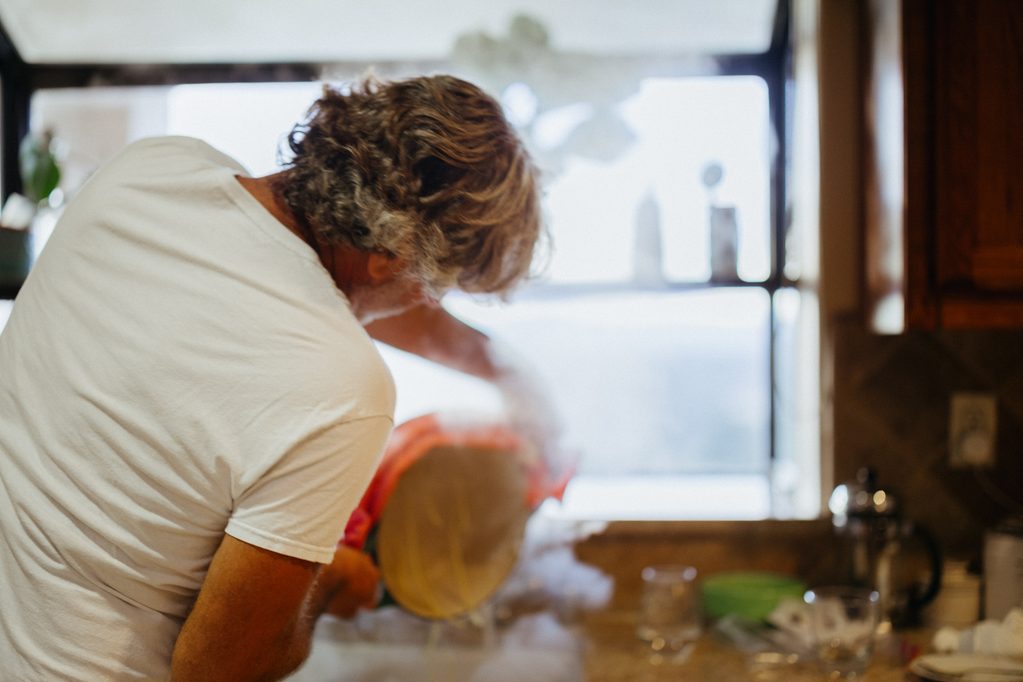 Person cooking with steam rising
